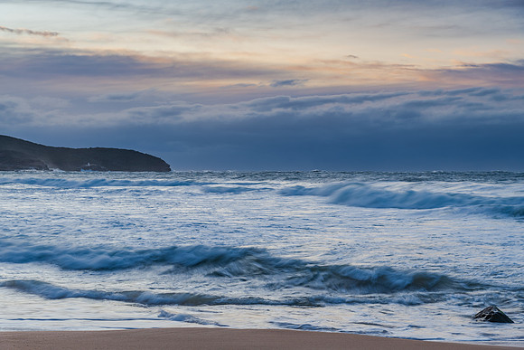 Cloud covered sunrise sesacape in soft pastel shades
