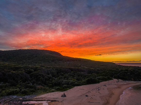 High cloud sunrise over the beach and mountain