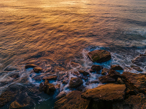 Top down over the ocean with rocks and ripples