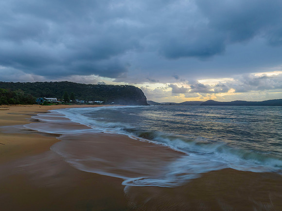 Sunrise seascape with overcast sky and rain clouds