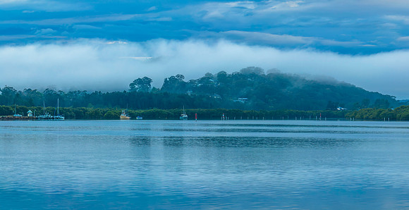 Respite from the rain - Bay waterscape with boats and mist