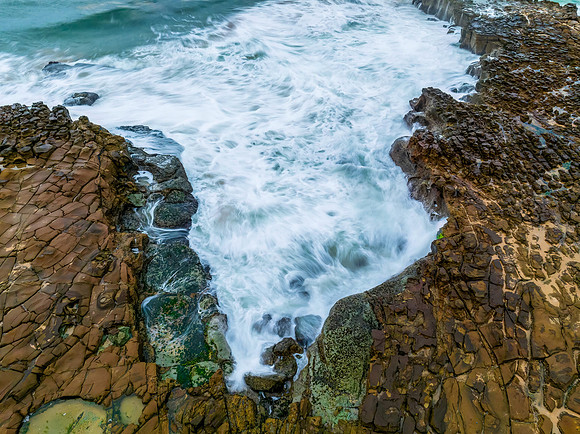 Rainy day sunrise seascape and rock platform