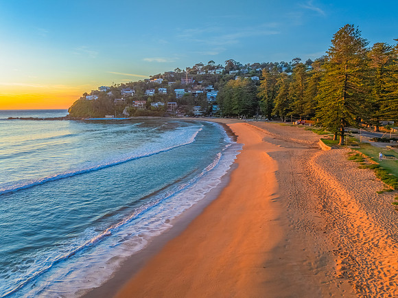 Ocean Sunrise Under Clear Skies with Orange Horizon