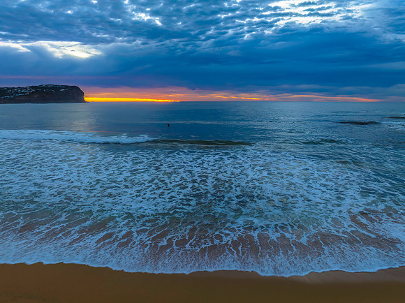Cloud filled sunrise seascape