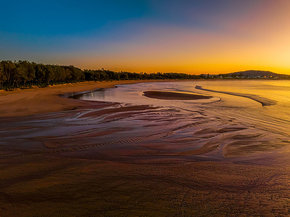 Aerial sunrise seascape with orange glow on a cold Winter's morn