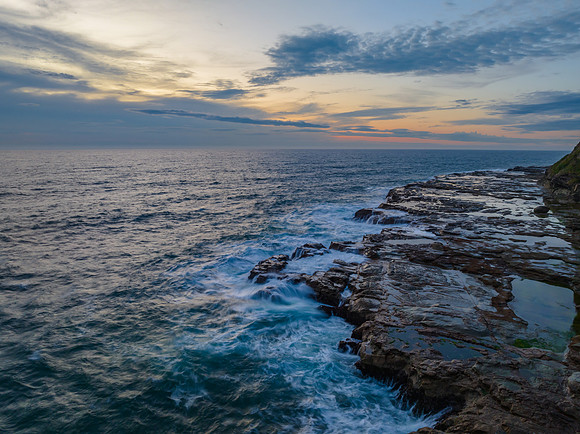 Dreamy soft-hued sunrise seascape over the ocean with high cloud