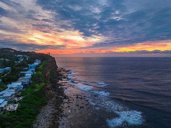 Pastel cloud covered sunrise seascape