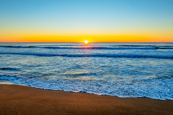 Sunrise at the seaside with a cloudless sky
