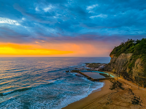 Pretty Sunrise at the seaside with rain clouds