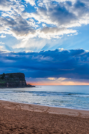 Winter sunrise by the sea shore with rain clouds