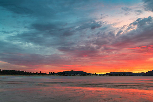 Colourful cloud filled sunrise at the seaside