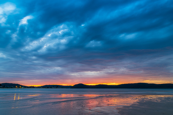 Colourful cloud filled sunrise at the seaside