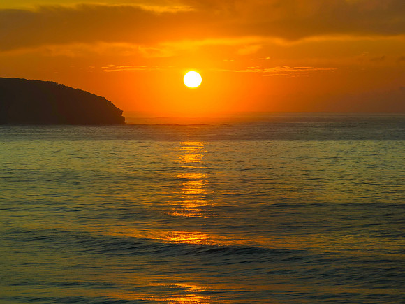 Golden path to the sun over the ocean