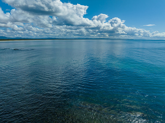 Cumulus clouds and the ocean on a beautiful Spring day