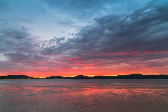 Colourful cloud filled sunrise at the seaside