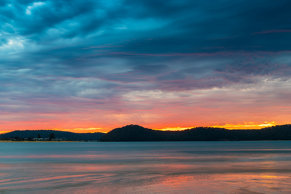 Colourful cloud filled sunrise at the seaside
