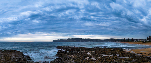 Rainy day sunrise seascape and rock platform