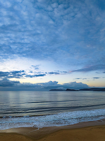 Aerial sunrise seascape with rain clouds