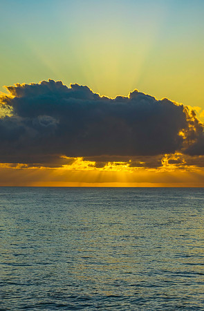 Sunrise seascape with crepuscular rays lighting up the sky