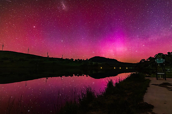 Aurora Australis display lights up the sky in pinks over the dam