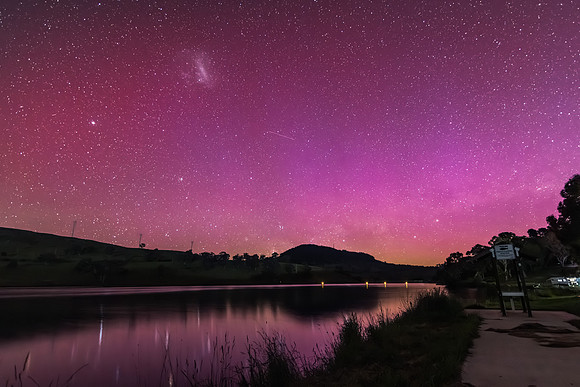 Aurora Australis display lights up the sky in pinks over the dam