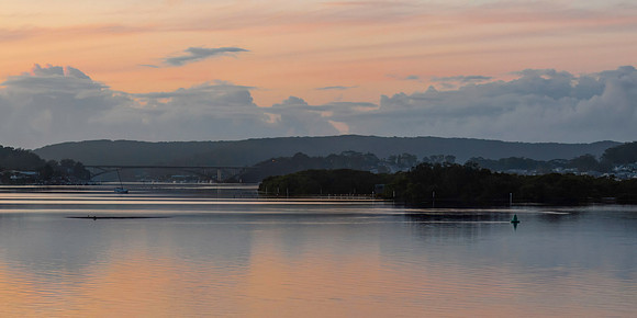 Soft pink sunrise waterscape panorama over the bay