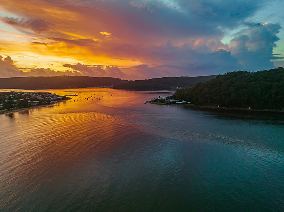 Aerial sunrise waterscape with boats, colour and clouds