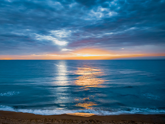 Sunrise at the Seaside with rain clouds