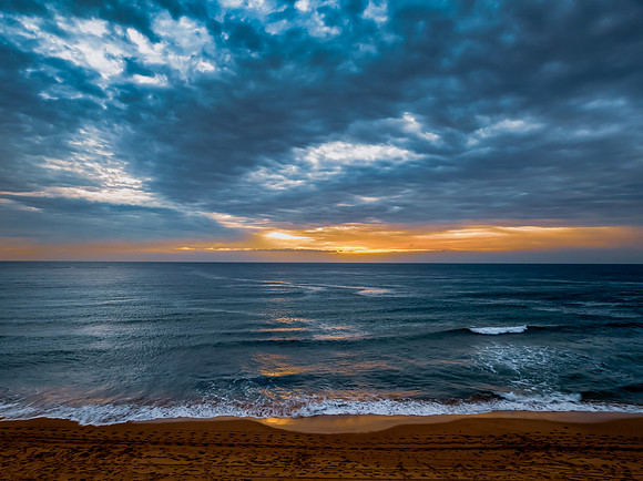 Sunrise at the Seaside with rain clouds