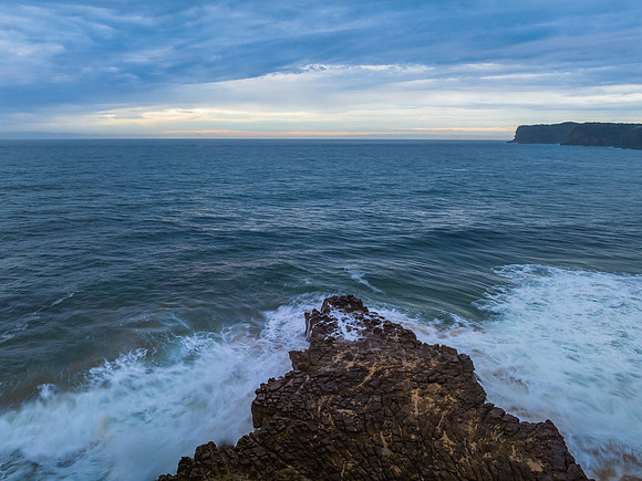 Rainy day sunrise seascape and rock platform