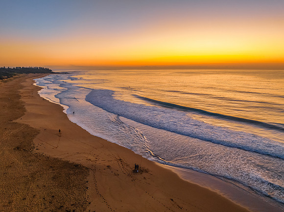Aerial sunrise at the beach with clear skies
