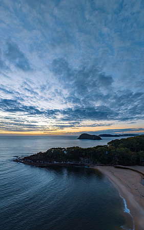 Aerial sunrise seascape with calm seas and a mix of low and medi