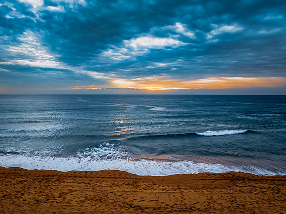 Sunrise at the Seaside with rain clouds