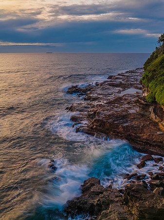 Aerial sunrise at the seaside in shades of blue and grey