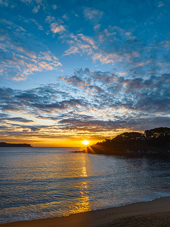 Aerial sunrise seascape with calm seas and a mix of low and medi