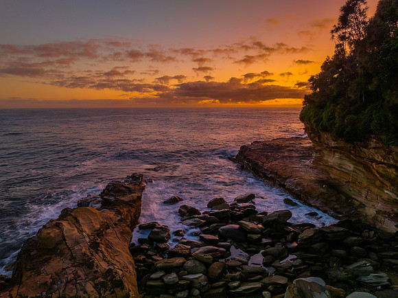 Dawn by the ocean with rocks