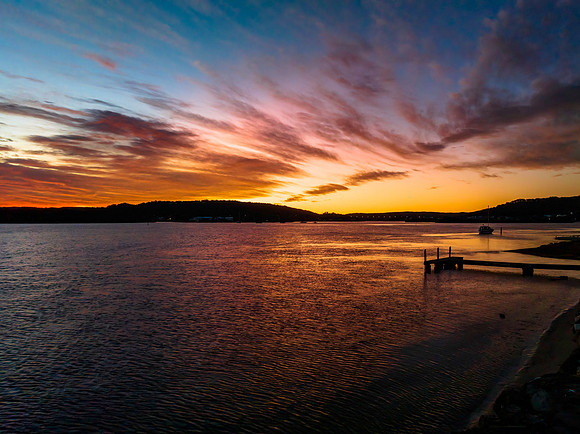Dawn waterscape with high cloud over the bay