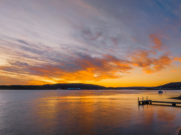 High cloud sunrise at the waterfront