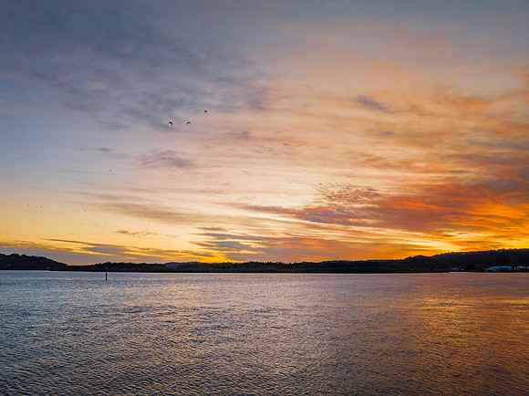 High cloud sunrise at the waterfront
