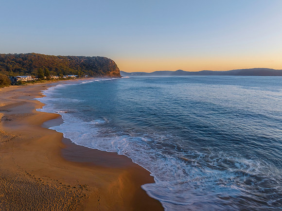 Aerial sunrise seascape with calm seas and a clear sky