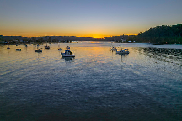 Aerial sunrise waterscape with boats and clear skies