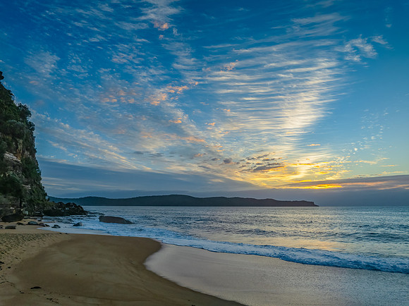 Sunrise, clouds and surf at the seaside