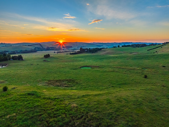 Sunrise over the countryside on the outskirts of country town wi