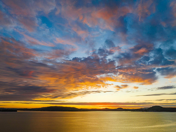 All about the sky - Aerial sunrise over the bay with clouds