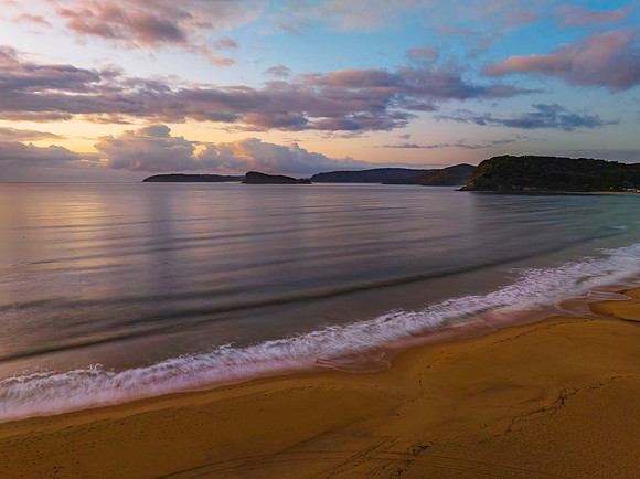 Aerial sunrise seascape with rain clouds