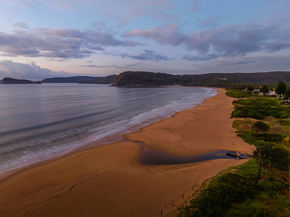 Aerial sunrise seascape with rain clouds