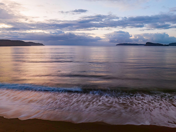 Aerial sunrise seascape with rain clouds