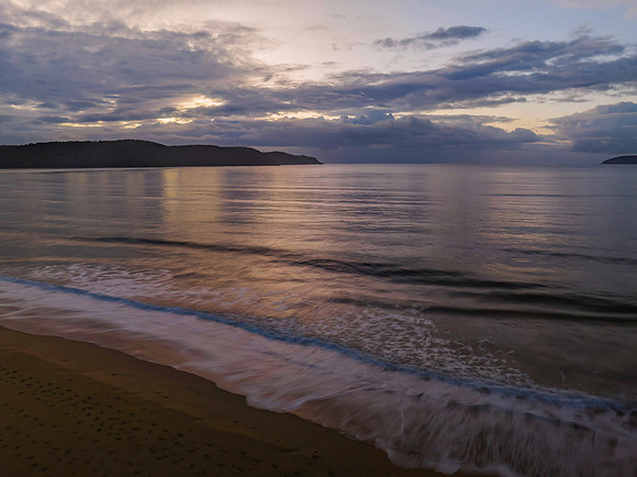 Aerial sunrise seascape with rain clouds