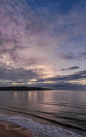 Aerial sunrise seascape with rain clouds