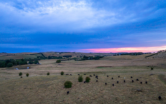 Aerial Sunset views over rural farmland with storm clouds and co